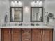 Bathroom with dual sinks, granite countertops, and framed mirrors at 10515 Canary Isle Dr, Tampa, FL 33647