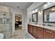 Bathroom with double sink vanity, separate shower and a view of the main bedroom at 10515 Canary Isle Dr, Tampa, FL 33647