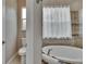 Bathroom featuring a soaking tub, shower with tile surround, and window at 10515 Canary Isle Dr, Tampa, FL 33647