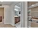 Bright bathroom featuring a wooden vanity with marble countertop and a shelved linen closet at 10515 Canary Isle Dr, Tampa, FL 33647