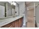 Bathroom featuring a sleek marble countertop vanity with a decorative mirror, and neutral color scheme at 10515 Canary Isle Dr, Tampa, FL 33647