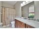 Bathroom featuring cabinet storage, a mirror, and a toilet at 10515 Canary Isle Dr, Tampa, FL 33647