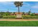 Exterior shot of the Beach Club entrance featuring lush landscaping and a prominent sign at 10515 Canary Isle Dr, Tampa, FL 33647