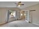 Bedroom with a vaulted ceiling, a ceiling fan and double doors at 10515 Canary Isle Dr, Tampa, FL 33647