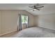 Bedroom with neutral carpet, window, ceiling fan, and vaulted ceiling at 10515 Canary Isle Dr, Tampa, FL 33647