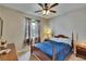 Bedroom with curtains and bed with a blue comforter at 10515 Canary Isle Dr, Tampa, FL 33647
