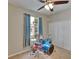 Bedroom with drumset, ceiling fan, window, and closet at 10515 Canary Isle Dr, Tampa, FL 33647