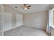 Bedroom with carpeted floor, ceiling fan, and closet at 10515 Canary Isle Dr, Tampa, FL 33647