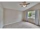 Bright bedroom featuring neutral carpet, window, and ceiling fan at 10515 Canary Isle Dr, Tampa, FL 33647