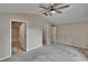 Bedroom featuring multiple doorways, ceiling fan, and neutral carpet at 10515 Canary Isle Dr, Tampa, FL 33647