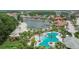 Aerial view of community pool and nearby playground and beach area by the lake at 10515 Canary Isle Dr, Tampa, FL 33647