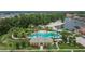 Aerial view of the community pool and recreation area with a sandy beach and lake views at 10515 Canary Isle Dr, Tampa, FL 33647