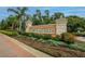 Stone monument sign for Cory Lake Isles with lush landscaping and palm trees, welcoming residents and visitors alike at 10515 Canary Isle Dr, Tampa, FL 33647