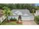 Beautiful home featuring lush landscaping, a three-car garage, and a well-maintained roof at 10515 Canary Isle Dr, Tampa, FL 33647