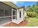 Rear exterior of the home showing a screened porch, a patio, and a lush backyard at 10515 Canary Isle Dr, Tampa, FL 33647