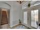 Spacious foyer with a decorative rug, large front door, stairs, and natural light at 10515 Canary Isle Dr, Tampa, FL 33647