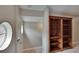 Hallway area with wooden bookshelf and unique circular window at 10515 Canary Isle Dr, Tampa, FL 33647