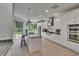 Bright kitchen features stainless appliances, custom cabinets, and oversized island with seating at 10515 Canary Isle Dr, Tampa, FL 33647