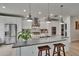 Bright kitchen features stainless appliances, custom cabinets, and an oversized island at 10515 Canary Isle Dr, Tampa, FL 33647
