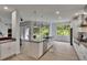 Bright kitchen features stainless appliances, custom cabinets, and oversized island with seating at 10515 Canary Isle Dr, Tampa, FL 33647