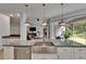 Bright kitchen features stainless appliances, custom cabinets, and oversized island with seating at 10515 Canary Isle Dr, Tampa, FL 33647
