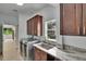 Well-lit laundry room features a washer, dryer, storage cabinets, sink and a marble countertop at 10515 Canary Isle Dr, Tampa, FL 33647