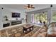 Bright living room with a fireplace, sliding doors to the patio, and comfortable seating at 10515 Canary Isle Dr, Tampa, FL 33647