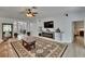 Well-lit living room featuring a decorative rug, fireplace, and modern flooring at 10515 Canary Isle Dr, Tampa, FL 33647
