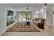 Open living room with a fireplace, sliding glass doors, and a stylish leather sofa at 10515 Canary Isle Dr, Tampa, FL 33647