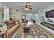 Spacious living room featuring modern flooring, fireplace, and view of the dining room at 10515 Canary Isle Dr, Tampa, FL 33647