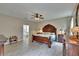 Spacious main bedroom includes wood furnishings, ceiling fan and an attached bathroom at 10515 Canary Isle Dr, Tampa, FL 33647