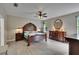 Spacious main bedroom features a ceiling fan, wood furnishings and wood-look flooring at 10515 Canary Isle Dr, Tampa, FL 33647