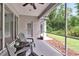 Relaxing screened porch with comfortable seating, a ceiling fan, and a lush backyard view at 10515 Canary Isle Dr, Tampa, FL 33647
