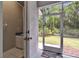 Screened porch with a view to the yard and an adjacent bathroom with a vanity at 10515 Canary Isle Dr, Tampa, FL 33647
