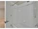 Bright shower with a white tiled wall surround, shower head, and a bathtub at 10515 Canary Isle Dr, Tampa, FL 33647