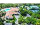 Aerial view of a clubhouse, pool, and tennis courts at 11121 Cherrywood Ct, Spring Hill, FL 34609