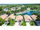 An aerial view shows a well-maintained home in a desirable neighborhood with mature trees and a tranquil lake at 11121 Cherrywood Ct, Spring Hill, FL 34609