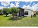 This home has a well-maintained lawn and a screened patio at 11121 Cherrywood Ct, Spring Hill, FL 34609