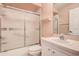 This bathroom features a shower-tub combo, glass shower doors, and a vanity with a sink at 11121 Cherrywood Ct, Spring Hill, FL 34609