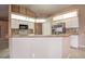 Bright kitchen boasts white cabinets, stainless steel appliances, and a breakfast bar for convenient dining at 11121 Cherrywood Ct, Spring Hill, FL 34609
