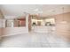 Open-concept living room showcasing tile floors and seamless transition into the kitchen area at 11121 Cherrywood Ct, Spring Hill, FL 34609