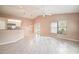 Open-concept living area with tiled floors and a seamless flow to the kitchen, perfect for entertaining at 11121 Cherrywood Ct, Spring Hill, FL 34609