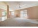 Bright living room featuring neutral walls, carpet, and large windows with views of the surrounding community at 11121 Cherrywood Ct, Spring Hill, FL 34609