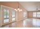 Spacious living room featuring tiled floor, French doors, and ample natural light at 11121 Cherrywood Ct, Spring Hill, FL 34609