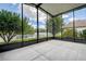 The screened patio overlooks lush landscaping and a tranquil pond at 11121 Cherrywood Ct, Spring Hill, FL 34609