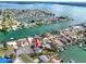 Aerial view of the waterfront property in a neighborhood surrounded by canals and waterways at 11465 7Th E St, Treasure Island, FL 33706