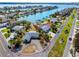 Aerial view of the property showcasing waterfront access, surrounding landscape, and proximity to the Gulf at 11465 7Th E St, Treasure Island, FL 33706