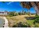 The grassy backyard is by the canal with lush green landscaping and direct water access at 11465 7Th E St, Treasure Island, FL 33706