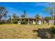 Spacious backyard featuring a sunroom and well-maintained lawn at 11465 7Th E St, Treasure Island, FL 33706