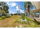 Overgrown backyard with partial waterfront views through the windows of the sunroom at 11465 7Th E St, Treasure Island, FL 33706